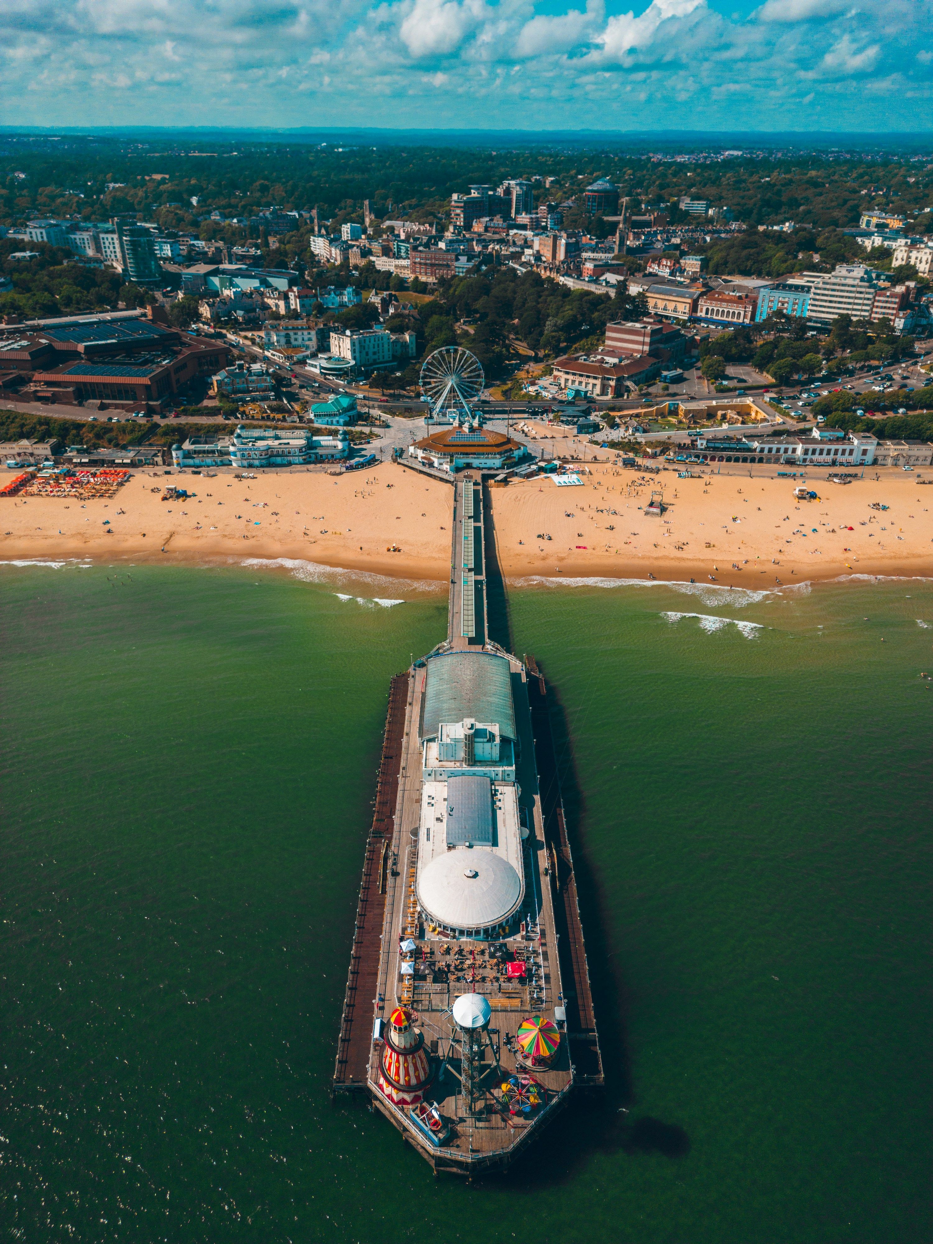 Aerial view straight down Bournemouth Pier to the beach, the big wheel and the town