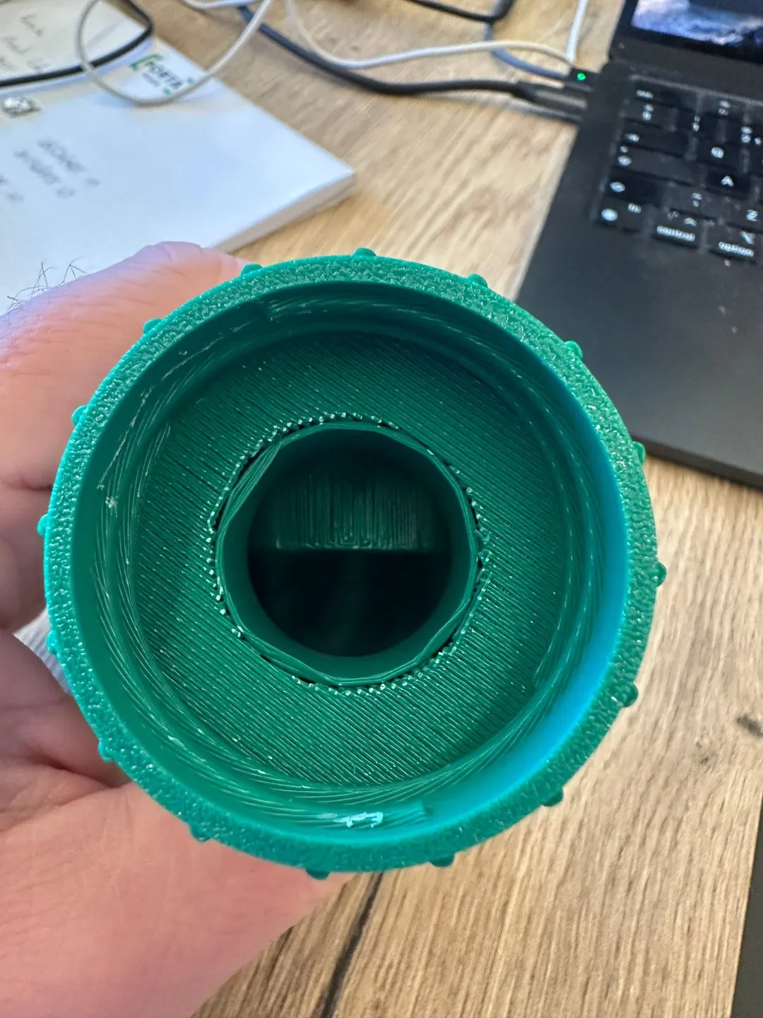 The first printed collar, viewed from the bottle side: a deep narrow bore